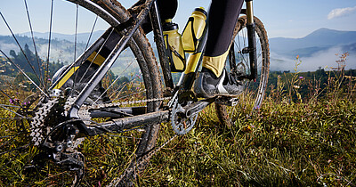 Young man riding a mountain bike downhill style